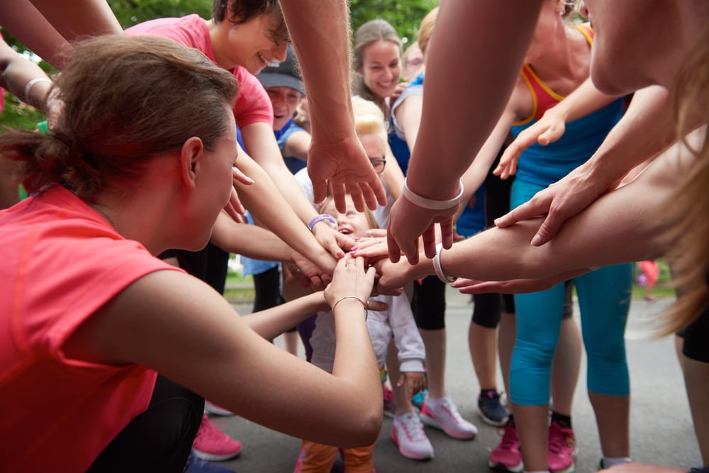 jogging people group, friends have fun,  hug and stack hands together after training